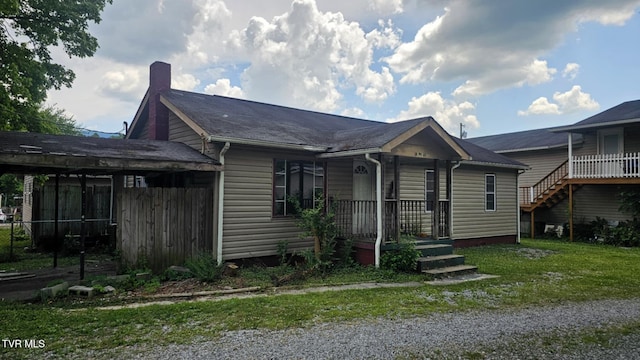 10 Powell Valley Rd, Big Stone Gap, VA 24219 - view of front facade featuring a carport, driveway, a chimney, and a front lawn
