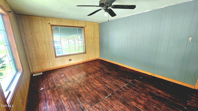 10 Powell Valley Rd, Big Stone Gap, VA 24219 - empty room with hardwood / wood-style floors, a ceiling fan, wood walls, and a textured ceiling
