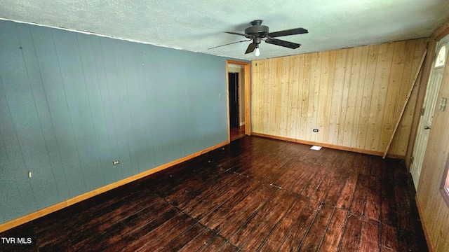 10 Powell Valley Rd, Big Stone Gap, VA 24219 - unfurnished room featuring wooden walls, hardwood / wood-style floors, ceiling fan, and a textured ceiling