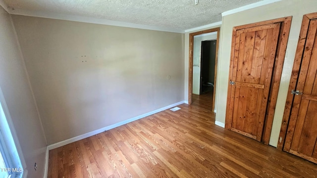 10 Powell Valley Rd, Big Stone Gap, VA 24219 - unfurnished bedroom featuring wood finished floors and a textured ceiling