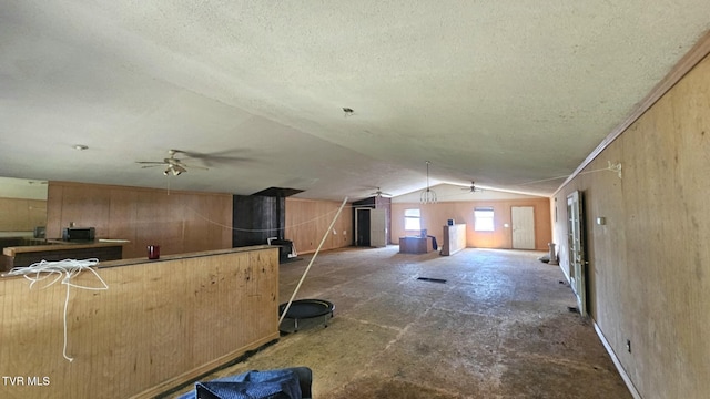 10 Powell Valley Rd, Big Stone Gap, VA 24219 - unfurnished living room with a ceiling fan, vaulted ceiling, and a textured ceiling