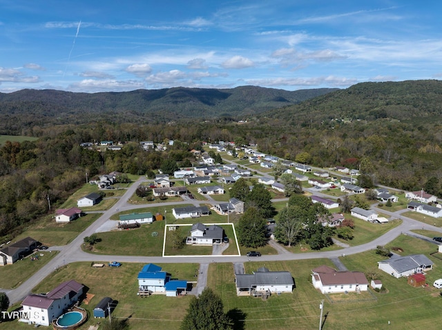 drone / aerial view featuring a forest view, a mountain view, and a residential view