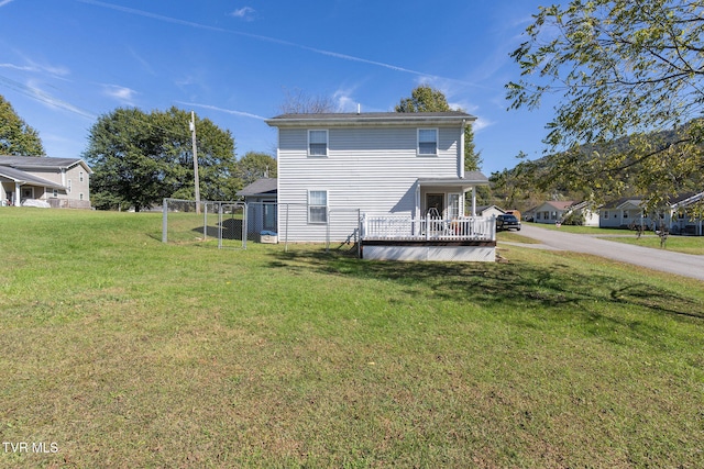 rear view of house featuring a lawn