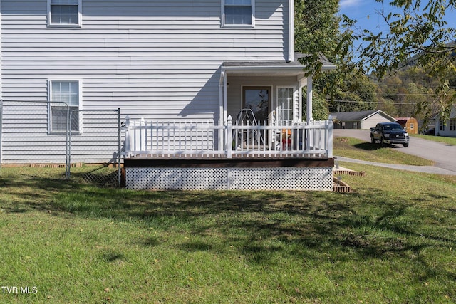 doorway to property with a yard and a deck