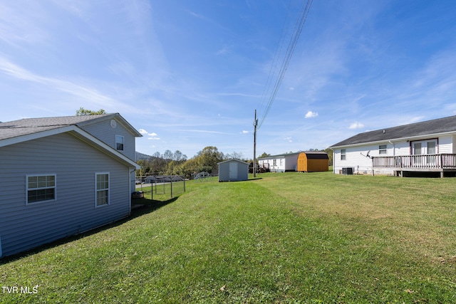 view of yard with a storage shed and central AC