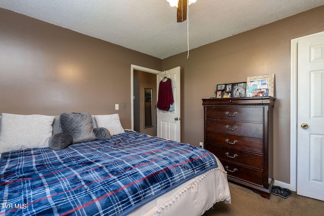 bedroom featuring ceiling fan, carpet floors, and a textured ceiling