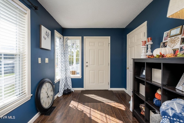 foyer featuring hardwood / wood-style flooring, baseboards, and visible vents