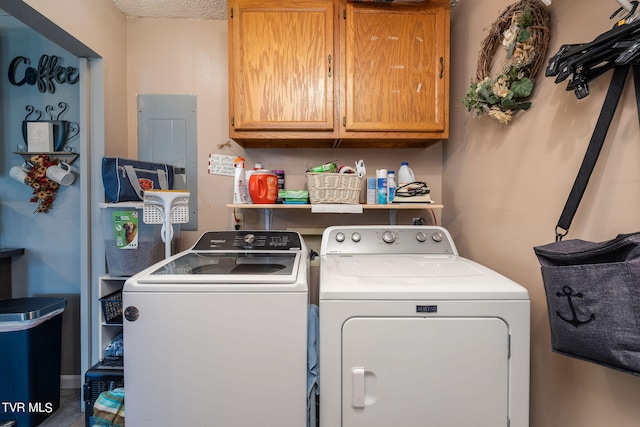 clothes washing area with separate washer and dryer, cabinets, and a textured ceiling