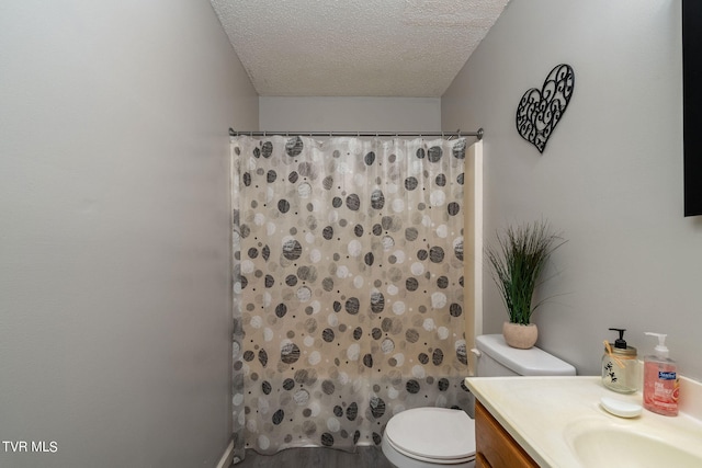 bathroom featuring vanity, toilet, a textured ceiling, hardwood / wood-style floors, and a shower with shower curtain