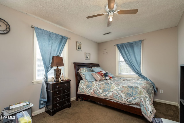 carpeted bedroom with ceiling fan, a textured ceiling, and multiple windows