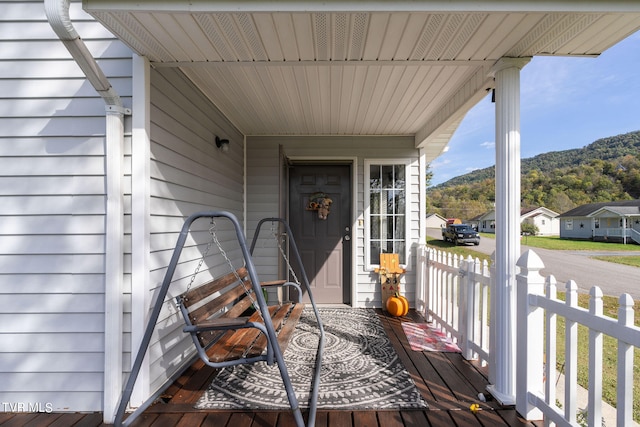 deck with a mountain view and a porch