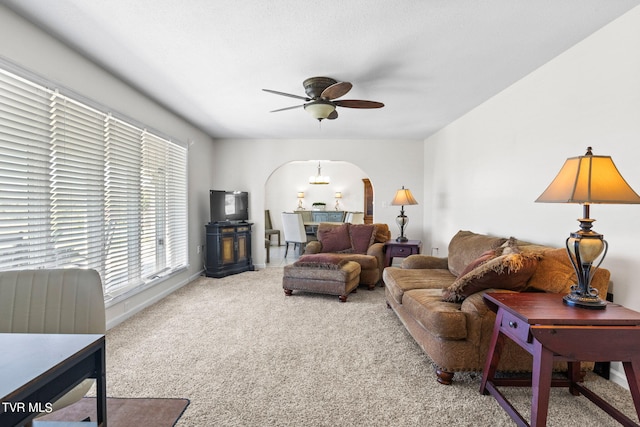 living room featuring ceiling fan and carpet