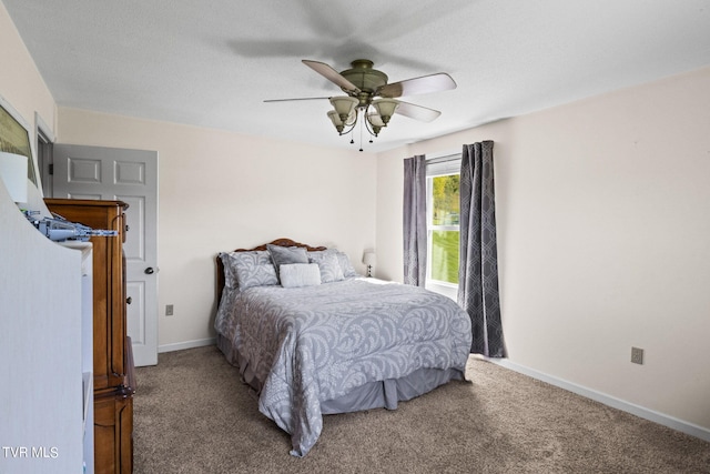 bedroom featuring ceiling fan and carpet