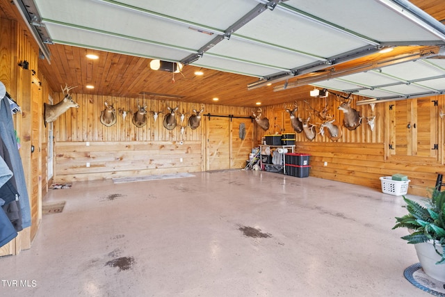 garage with a garage door opener and wooden walls