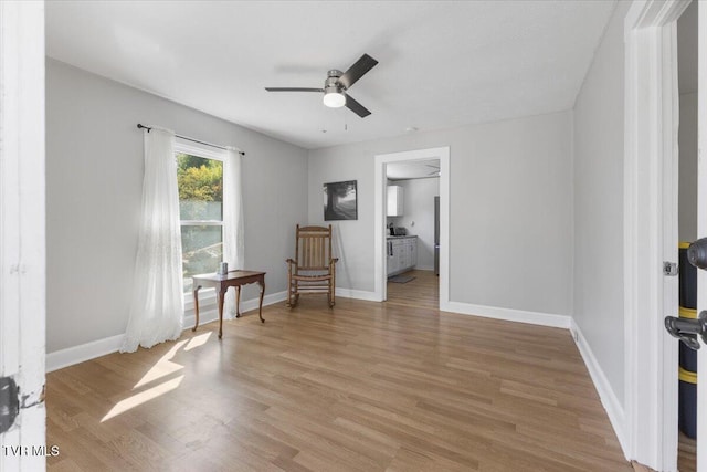 living area with hardwood / wood-style flooring and ceiling fan