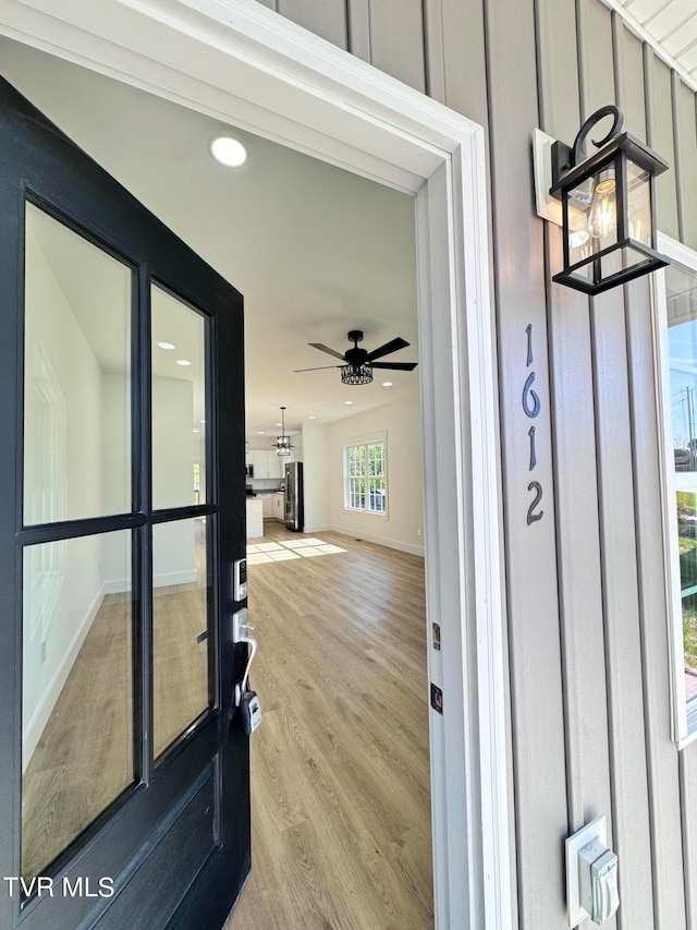 doorway to property with ceiling fan