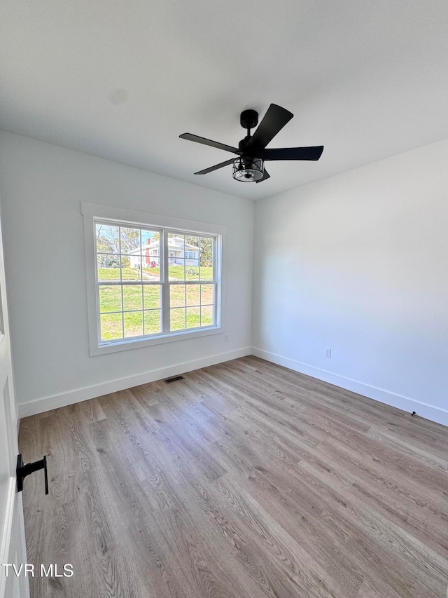 unfurnished room featuring ceiling fan and light hardwood / wood-style floors