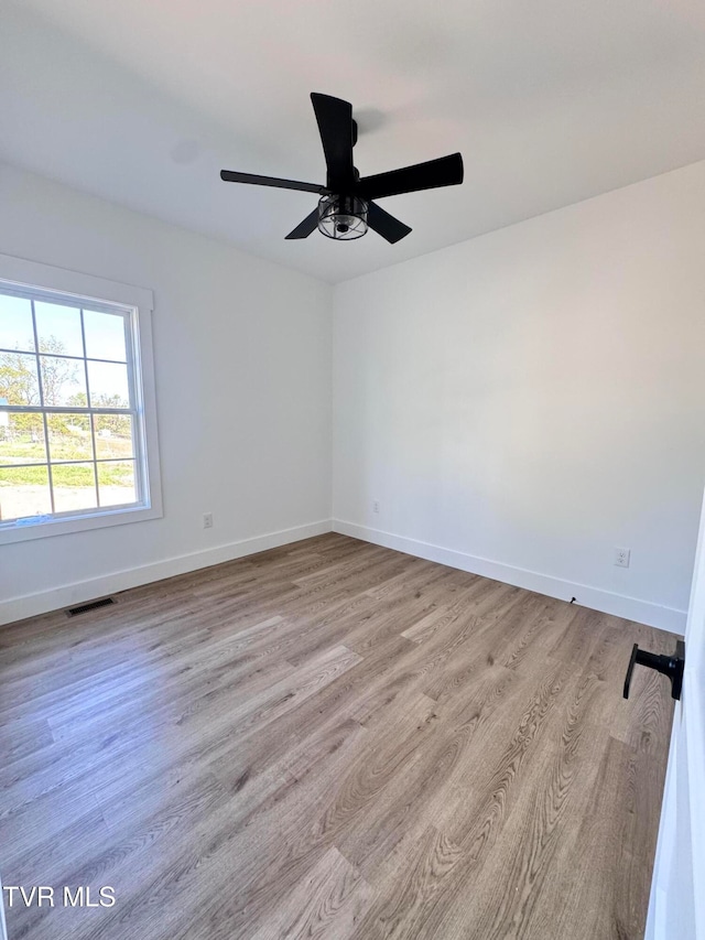 spare room featuring light hardwood / wood-style floors and ceiling fan