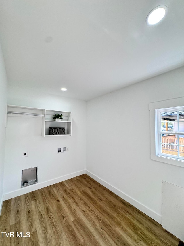 laundry room with electric dryer hookup, hookup for a washing machine, and hardwood / wood-style flooring