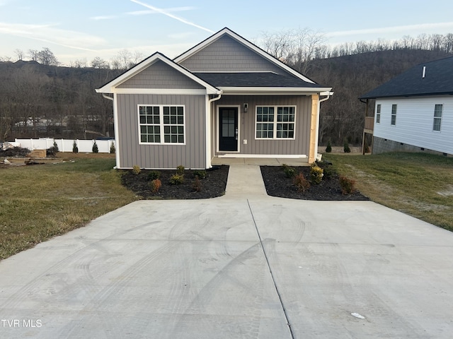 view of front of home with a porch and a front lawn