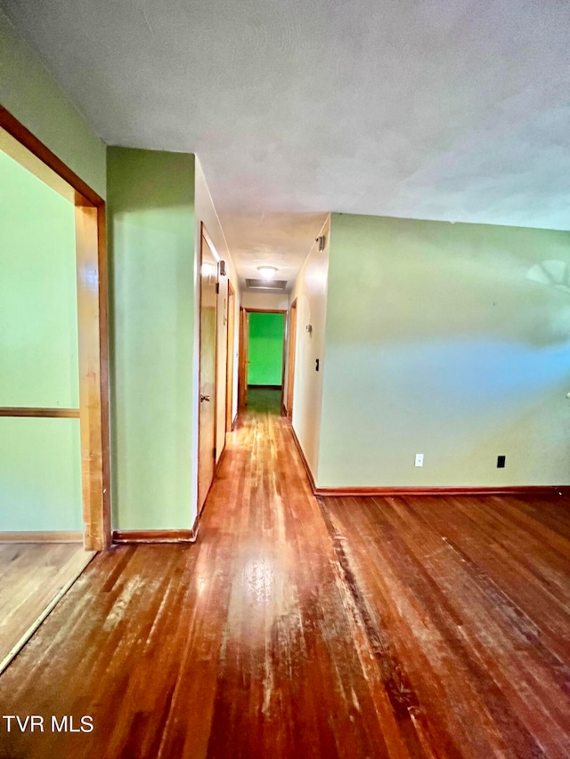 unfurnished room featuring hardwood / wood-style floors and a textured ceiling