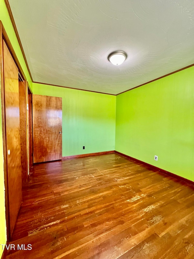 unfurnished room with hardwood / wood-style floors