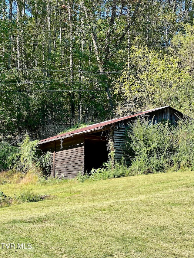 view of outdoor structure featuring a lawn