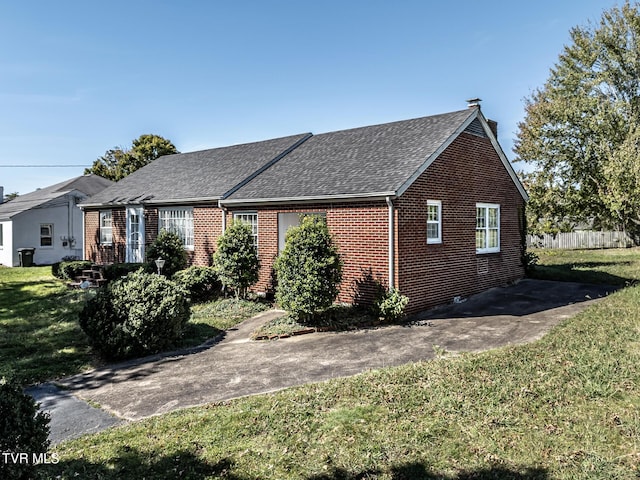 1021 Tusculum Blvd, Greeneville, TN 37745 - view of front of home with roof with shingles, brick siding, and a front lawn