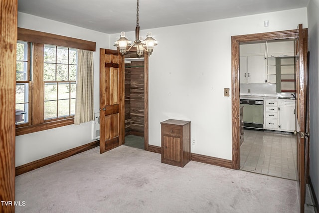 1021 Tusculum Blvd, Greeneville, TN 37745 - unfurnished dining area with baseboards, carpet, and a notable chandelier