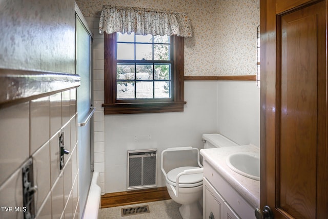 1021 Tusculum Blvd, Greeneville, TN 37745 - bathroom featuring vanity, wallpapered walls, heating unit, toilet, and visible vents