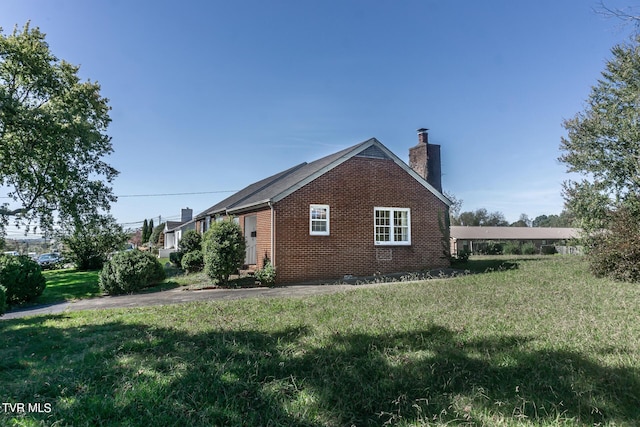 1021 Tusculum Blvd, Greeneville, TN 37745 - view of side of home with a chimney, a yard, and brick siding