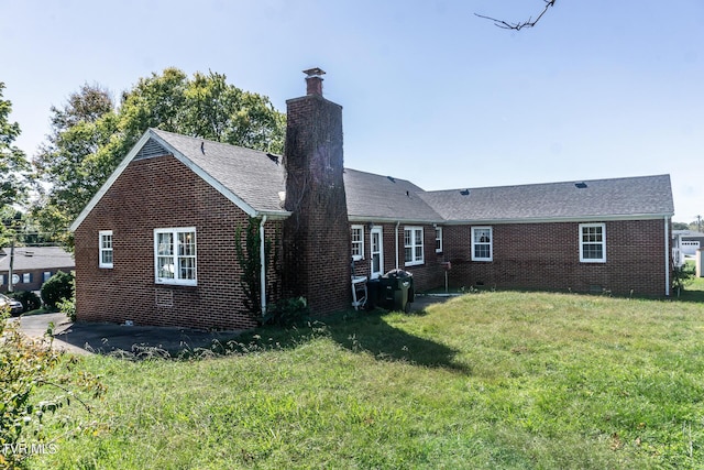 1021 Tusculum Blvd, Greeneville, TN 37745 - rear view of property featuring brick siding, a lawn, and a chimney