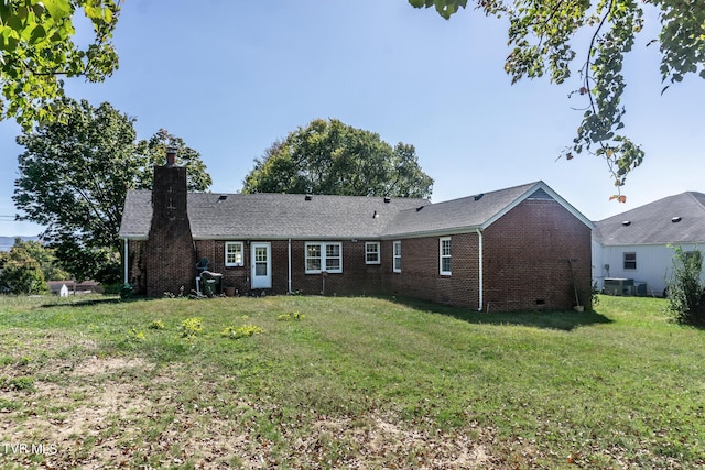 1021 Tusculum Blvd, Greeneville, TN 37745 - rear view of property with brick siding, a chimney, and a lawn