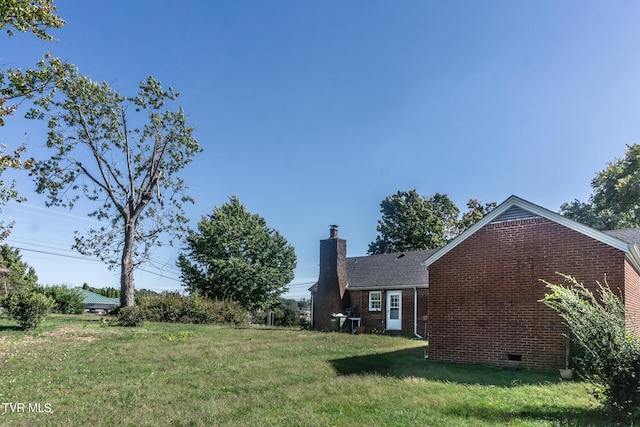 1021 Tusculum Blvd, Greeneville, TN 37745 - view of home's exterior with a yard, brick siding, crawl space, and a chimney