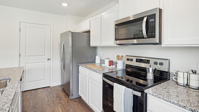 kitchen featuring light stone counters, dark wood-type flooring, white cabinetry, and stainless steel appliances