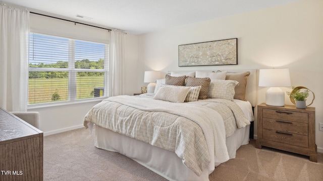 bedroom with light colored carpet