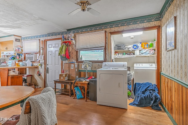 laundry area with hardwood / wood-style floors, washer and clothes dryer, a textured ceiling, and ceiling fan