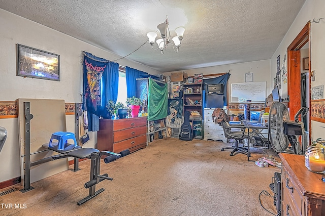 office area featuring a textured ceiling, a notable chandelier, and carpet flooring