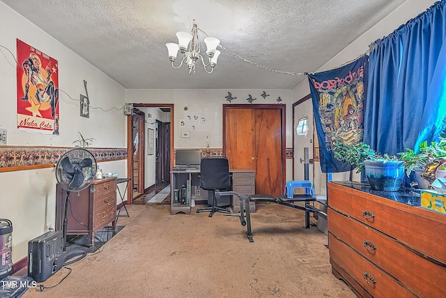 carpeted office space featuring a notable chandelier and a textured ceiling