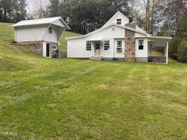 rear view of house featuring a lawn and a chimney