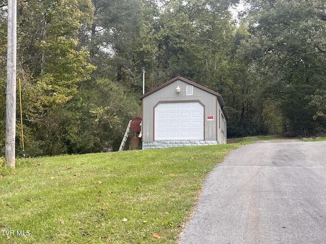 detached garage featuring a wooded view