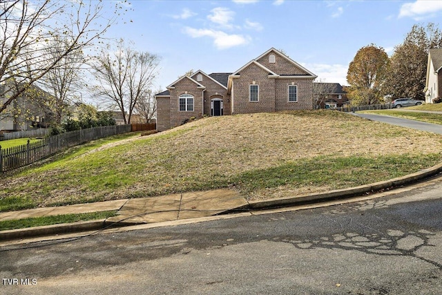 traditional-style home with brick siding and fence