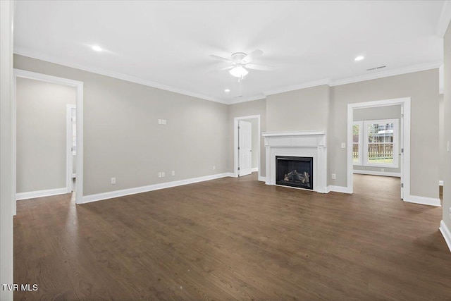 unfurnished living room featuring baseboards, a ceiling fan, dark wood-type flooring, crown molding, and a fireplace