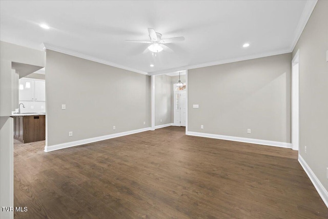 unfurnished room with dark wood-style floors, ceiling fan, baseboards, and crown molding