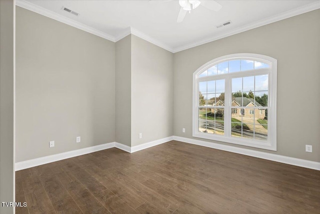 spare room featuring baseboards, visible vents, and dark wood finished floors