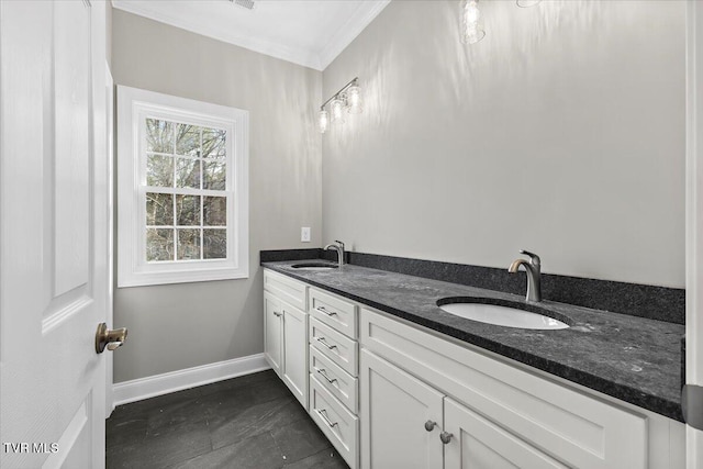 full bath with double vanity, crown molding, baseboards, and a sink