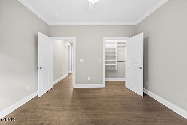 unfurnished bedroom with dark wood-style floors, baseboards, and ornamental molding