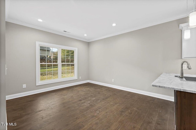 interior space featuring dark wood-style floors, a sink, and baseboards