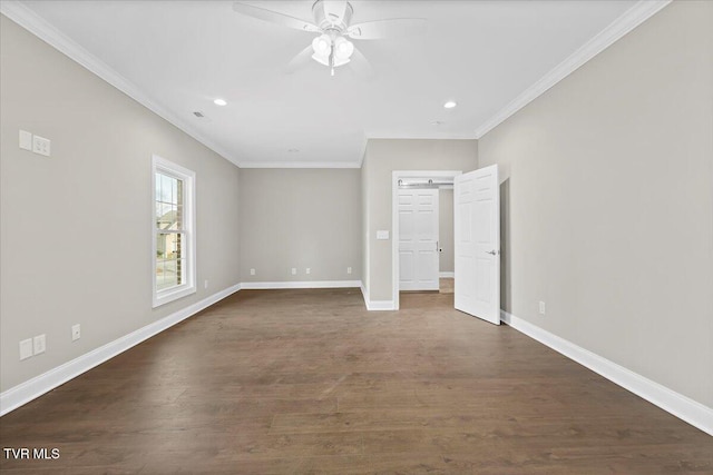 interior space with dark wood-style flooring, crown molding, and baseboards