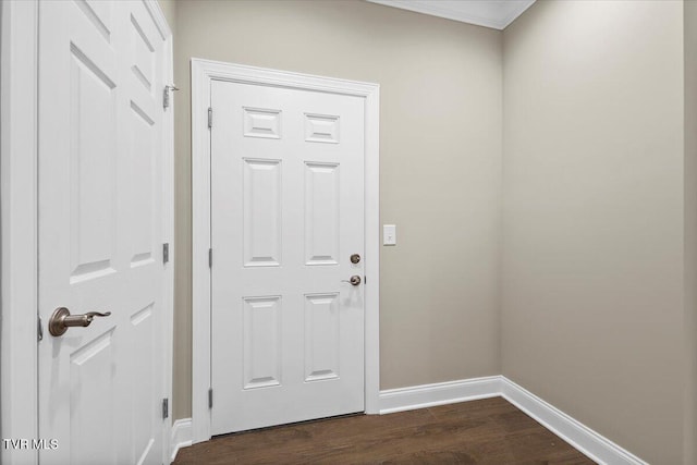 doorway with dark wood-style floors and baseboards